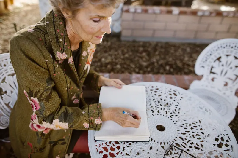 A resident writing in her notebook