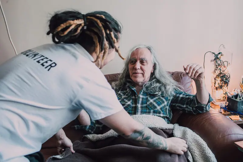 A volunteer visiting a resident at home
