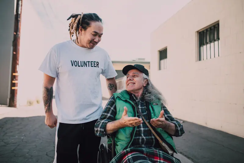 A young volunteer visiting with a resident