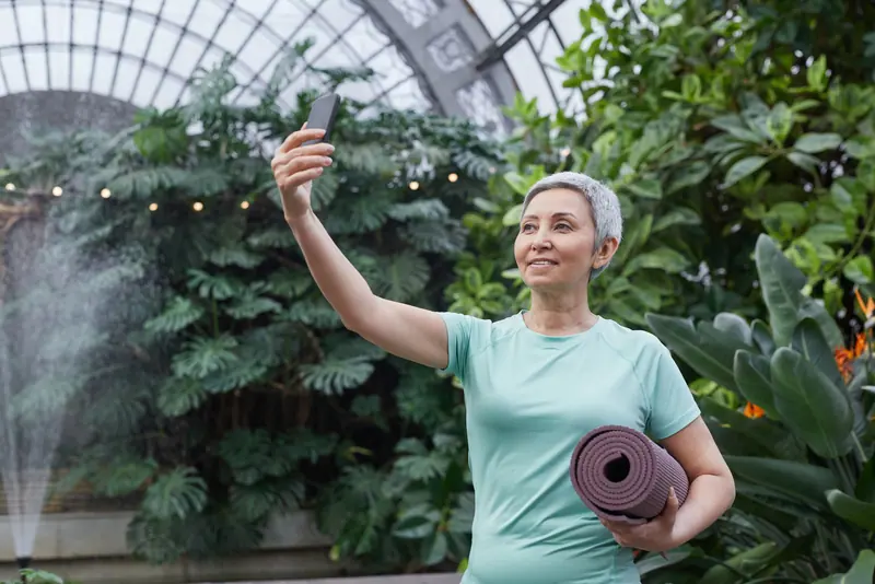 A resident taking a selfie in the greenhouse