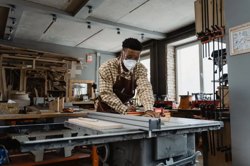 A resident turning a bowl in the woodshop