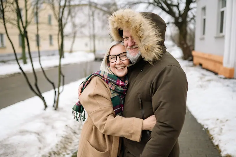 A couple embracing on a snowy afternoon