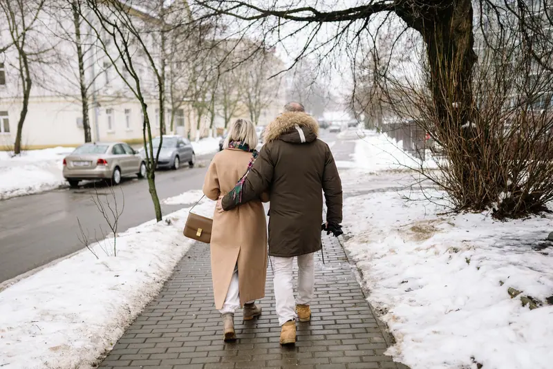 A couple walking a snowy street