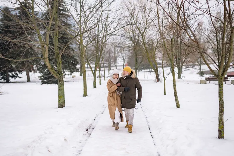 A couple walking a snowy path