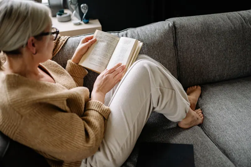 A resident reading on the sofa