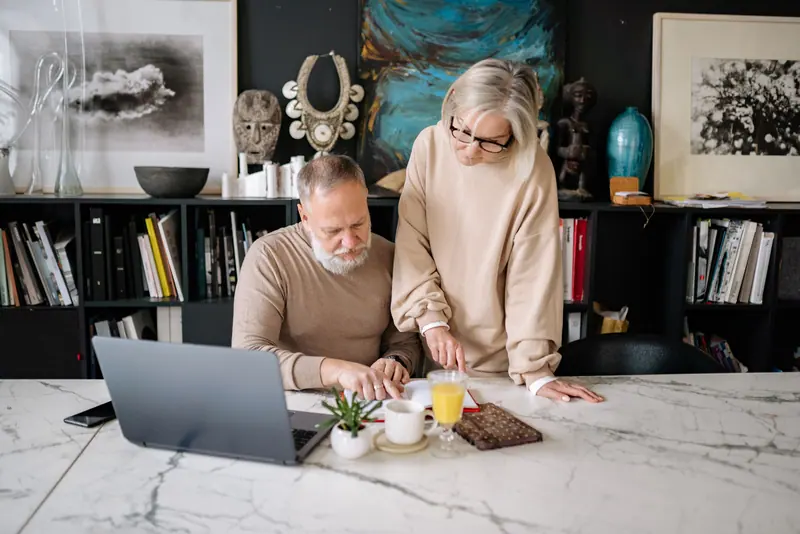 A couple planning a trip on the laptop
