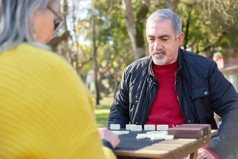 A resident studying his dominoes