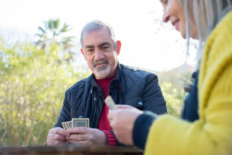 A couple playing cards in the garden