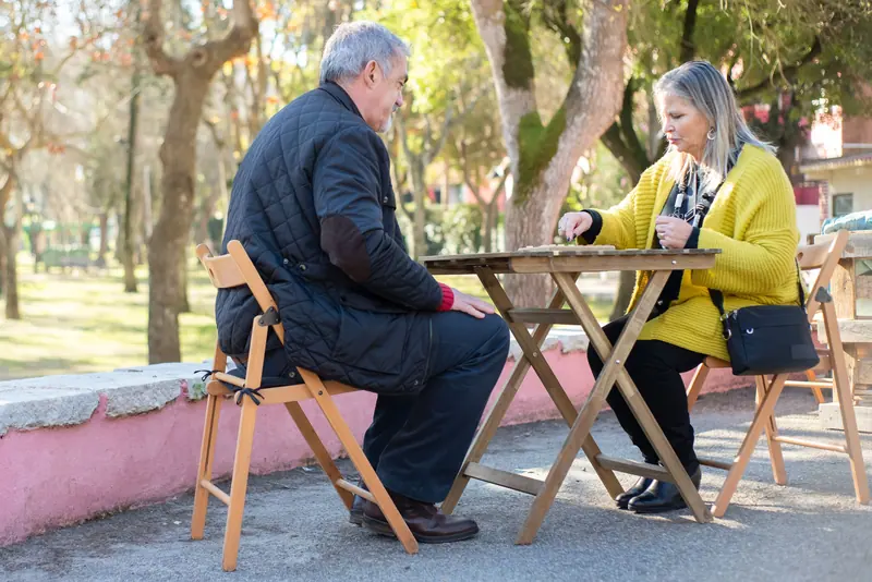 A couple with a board game on the porch