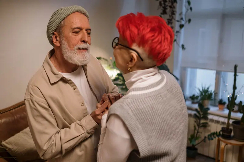A husband and wife sharing a tender moment in their residence