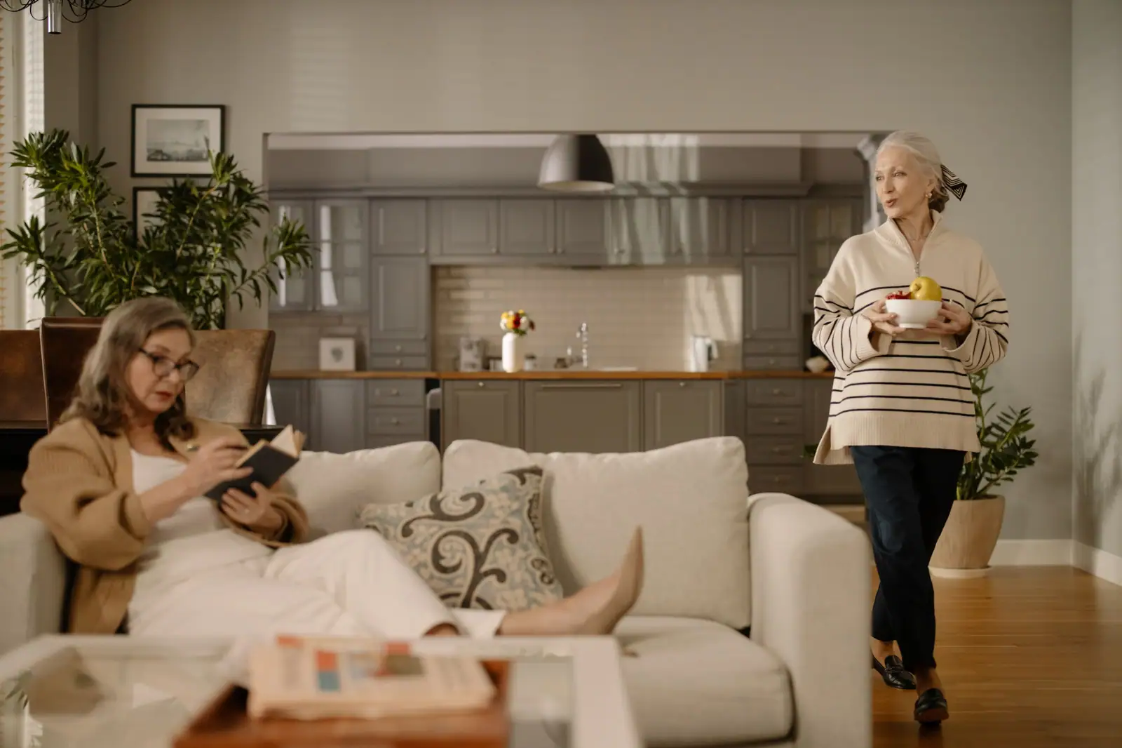 Two residents relaxing in a bright apartment living room
