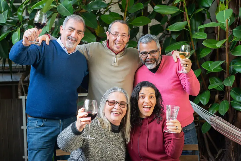 Friends raising a glass at a backyard birthday party