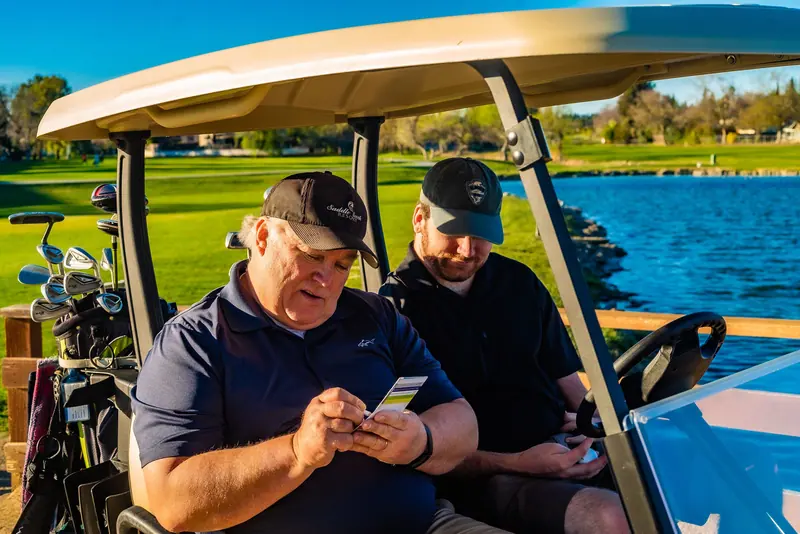 Two friends in a golf cart