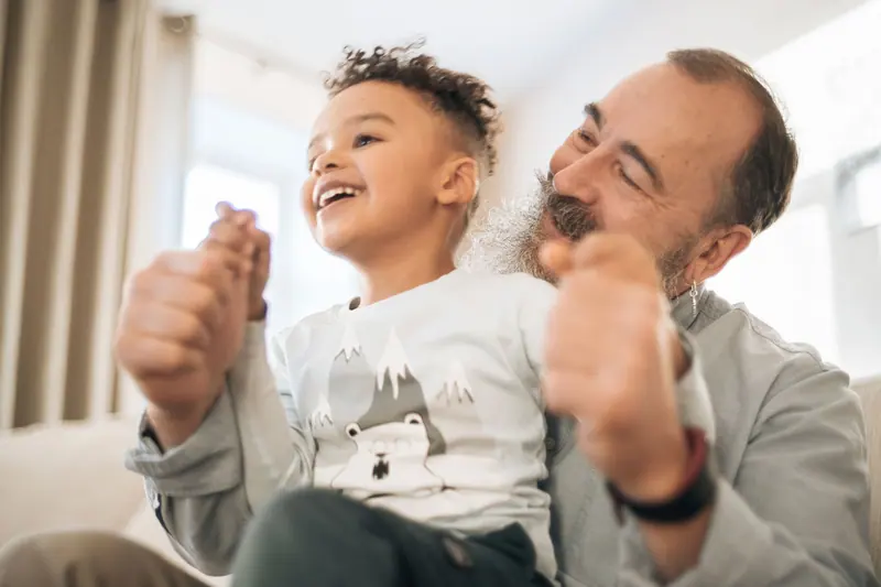 A grandfather and grandson sharing a laugh