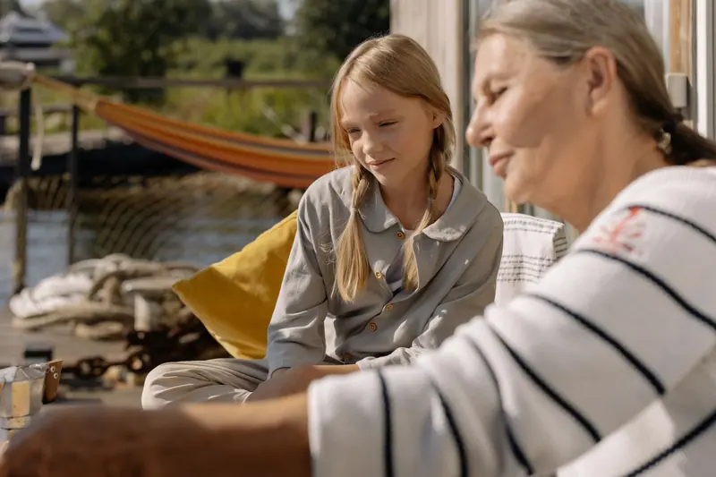 A grandmother and granddaughter on the patio