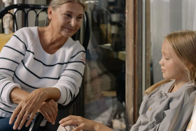 A grandmother and granddaughter sharing a quiet moment