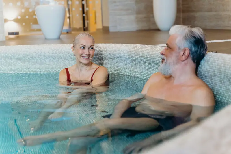 Two residents relaxing in the warm-water pool after a morning swim