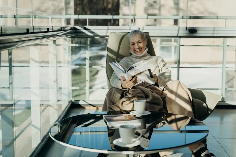 A resident reading a magazine by the window