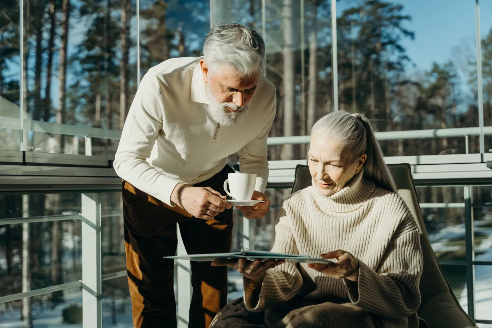 A couple with coffee and the paper in the sunroom