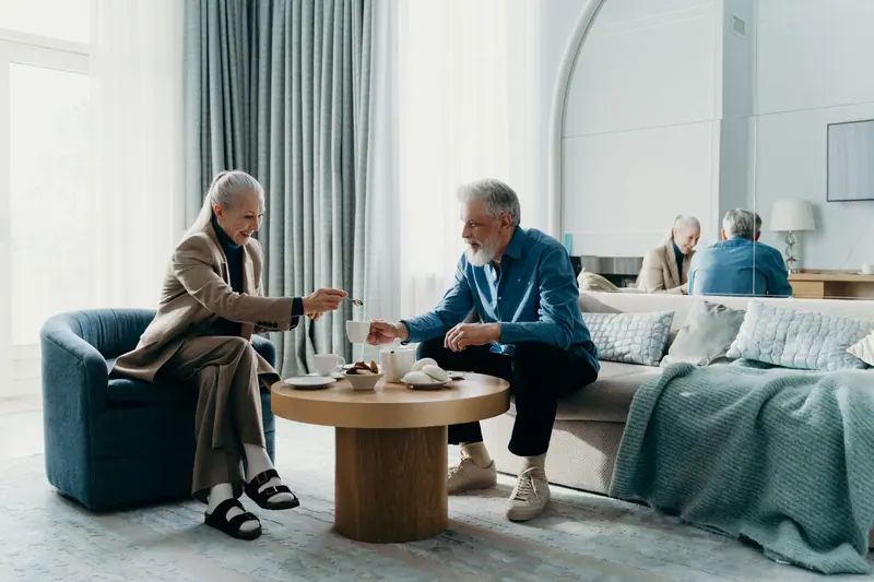 A couple with coffee in the parlor