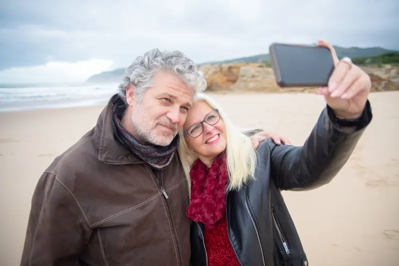 A couple taking a selfie on the shore