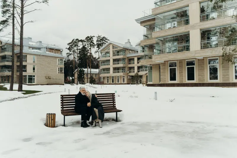 A couple on a bench in the snow