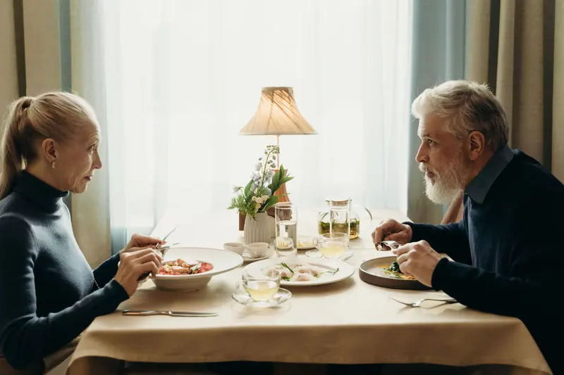 A couple at dinner in their apartment