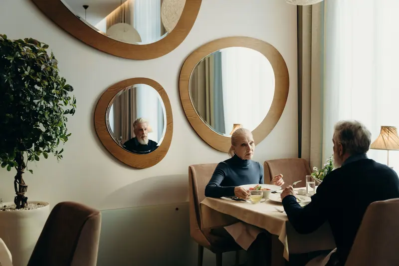 A couple dining by lamplight