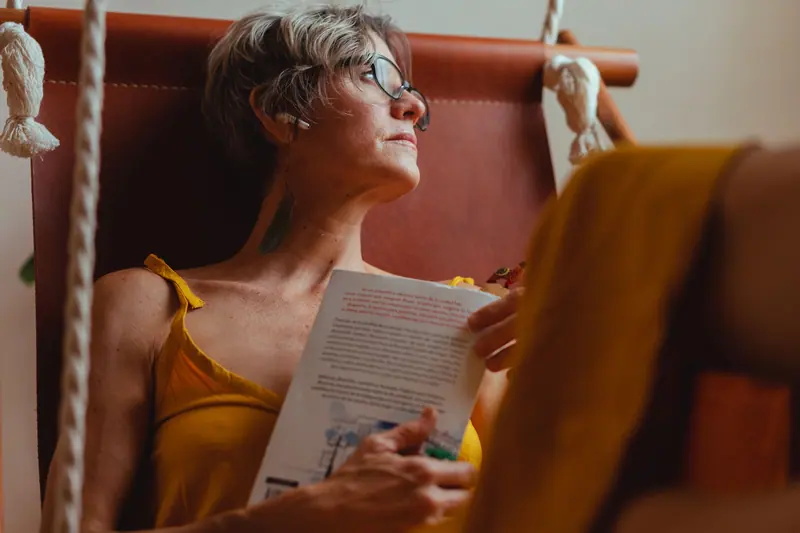 A resident reading in the hammock chair
