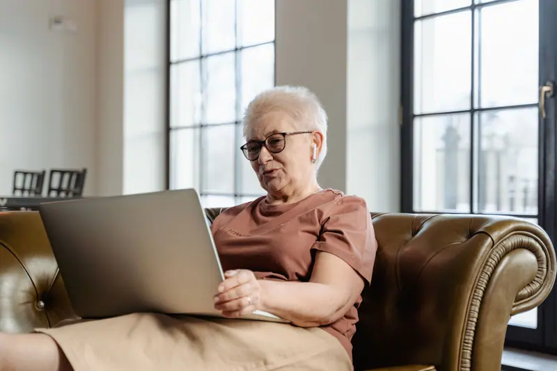 A resident on her laptop in the evening