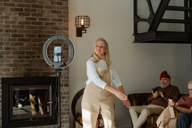 A resident dancing by the fireplace