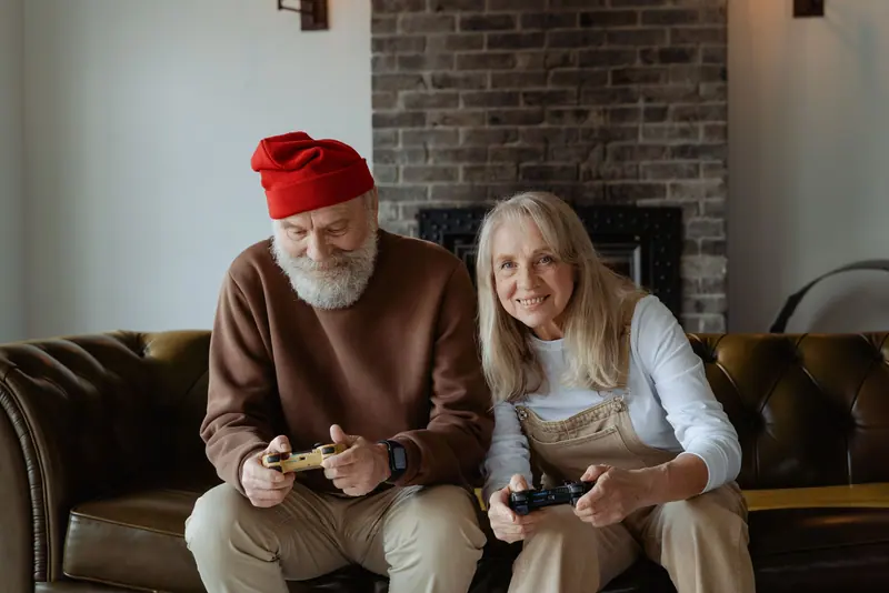 A couple laughing over a video game in the clubhouse lounge