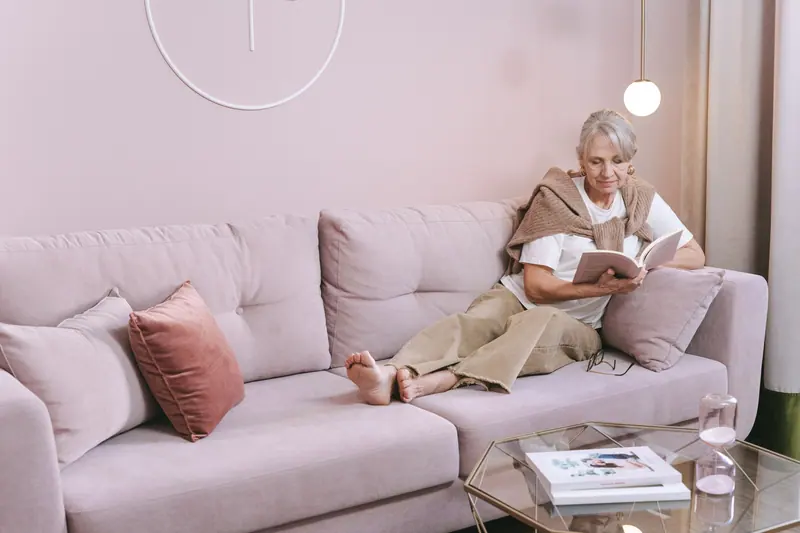 A resident reading in her apartment