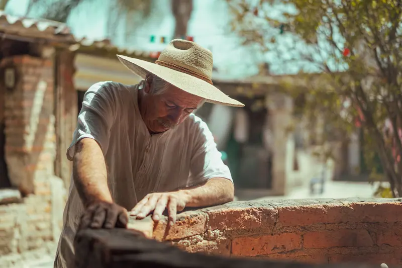 A resident laying brick for the new garden wall