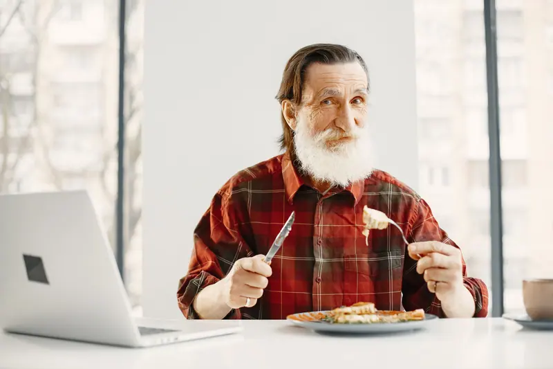A resident enjoying pasta at home