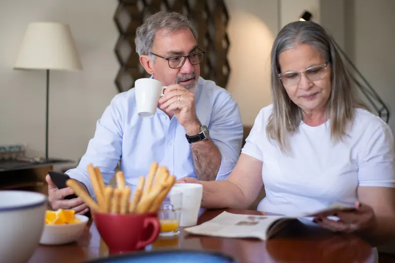 A couple with coffee and the newspaper