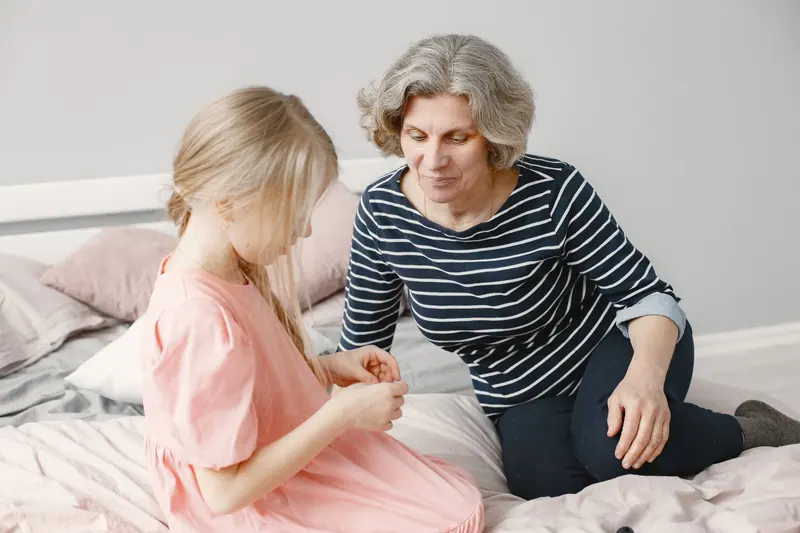 A grandmother playing with her granddaughter
