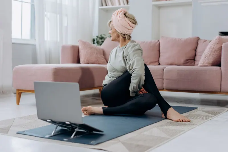 A resident following a yoga video