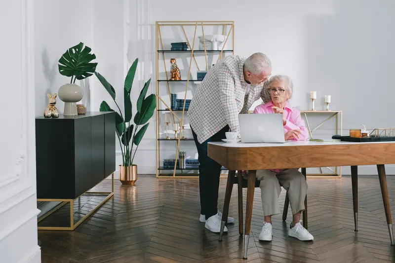 A couple at the desk in their apartment