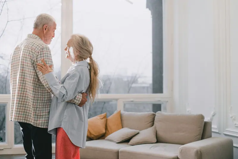 A couple dancing in their living room
