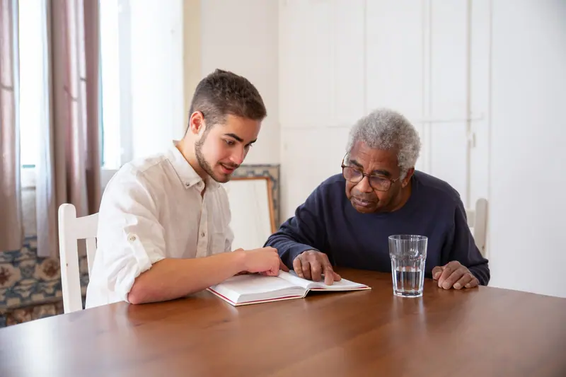 A young visitor reading with a resident