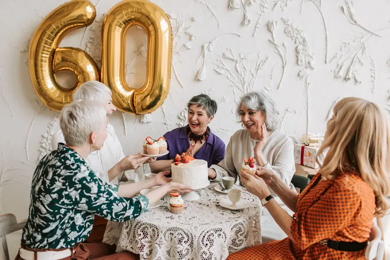 Friends gathered around the tea table for a birthday