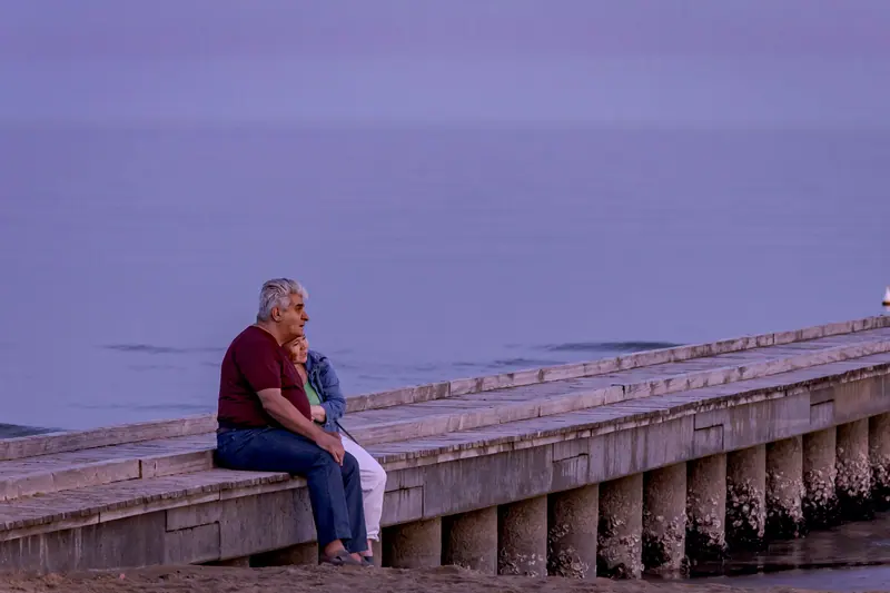 A couple on the old pier at dusk