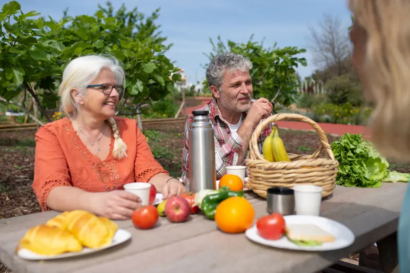 A couple at a picnic table in the garden