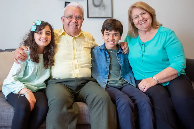 A couple with their grandchildren on the apartment sofa