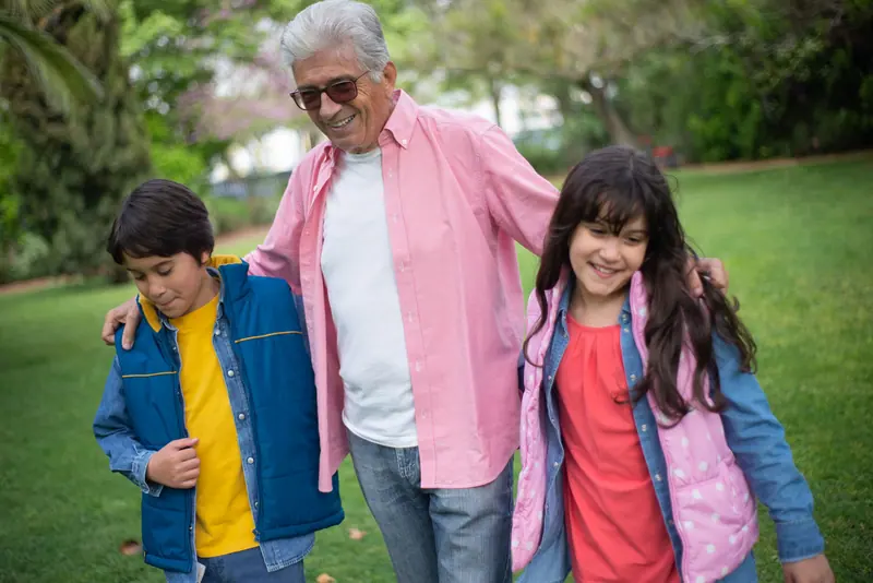 A resident walking the lawn with his grandchildren