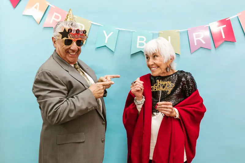 A birthday couple in party hats