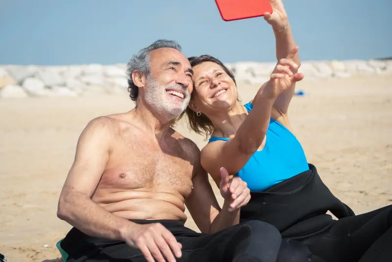 A couple taking a beach selfie