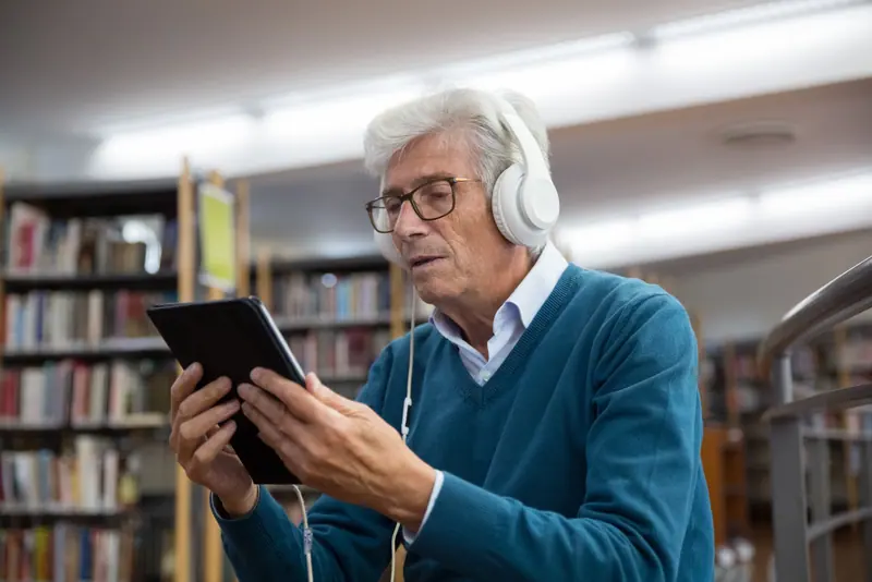 A resident listening to music in the library
