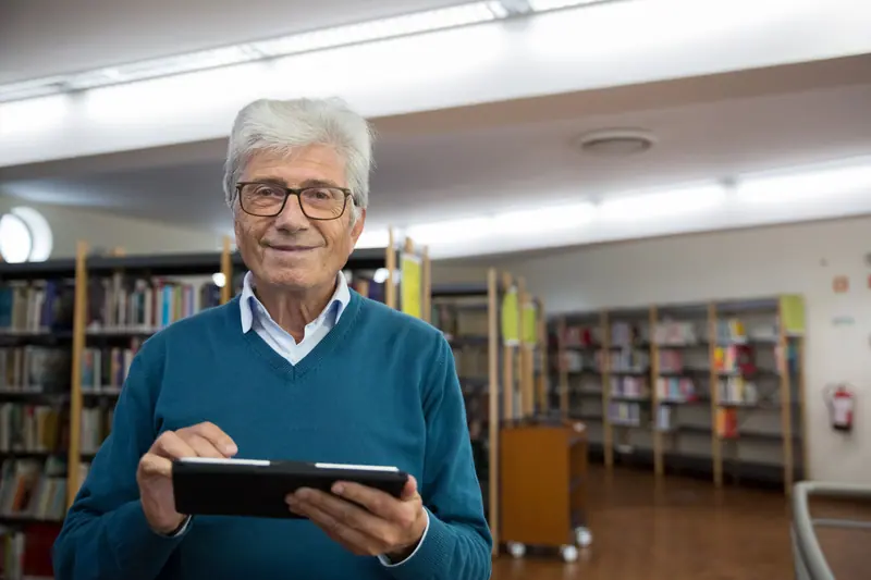 A resident with his tablet in the library